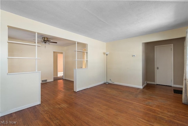 empty room with ceiling fan, a textured ceiling, and dark hardwood / wood-style flooring