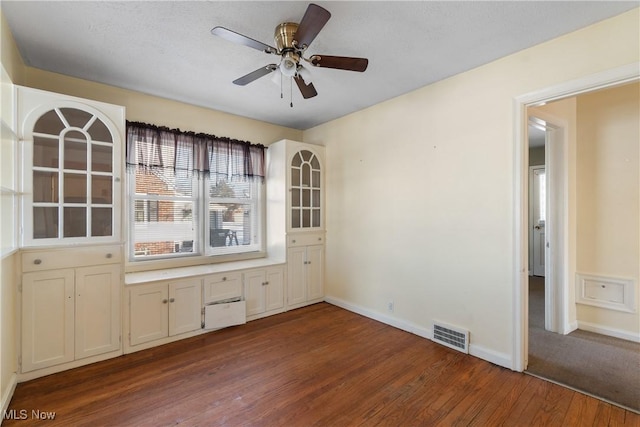 unfurnished dining area featuring hardwood / wood-style flooring and ceiling fan