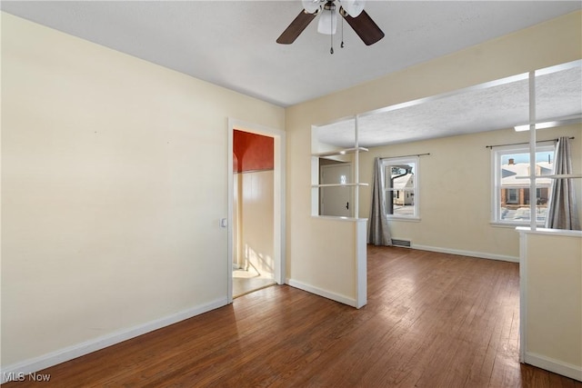 spare room featuring ceiling fan and dark hardwood / wood-style floors