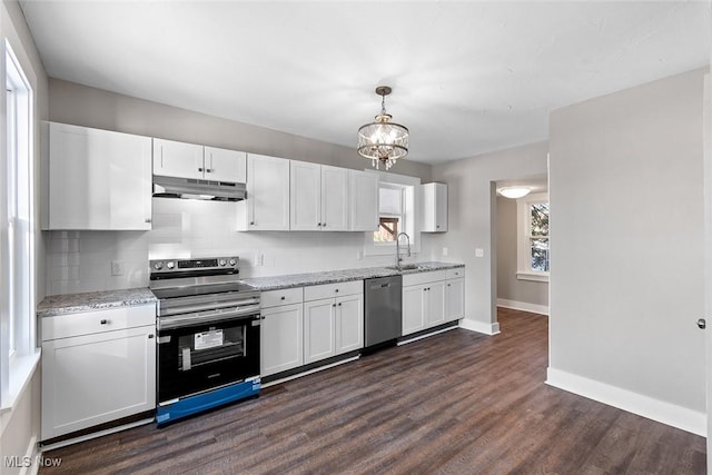 kitchen featuring appliances with stainless steel finishes, backsplash, decorative light fixtures, dark hardwood / wood-style flooring, and white cabinets