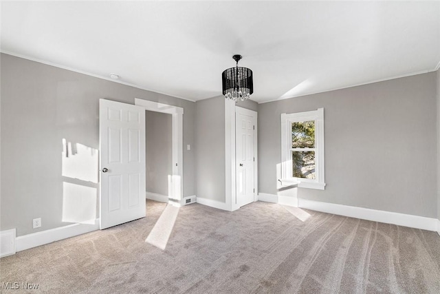 interior space featuring light carpet and an inviting chandelier