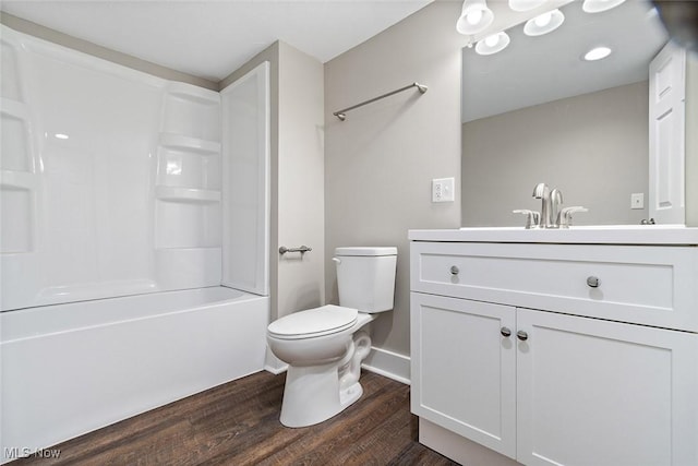 full bathroom with hardwood / wood-style flooring, tub / shower combination, toilet, and vanity