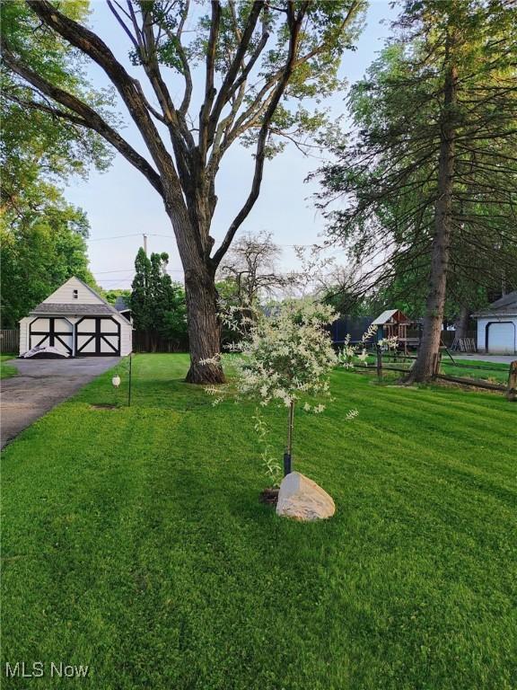 view of yard featuring a garage and an outdoor structure