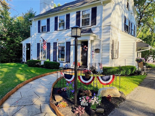 colonial home with a front yard