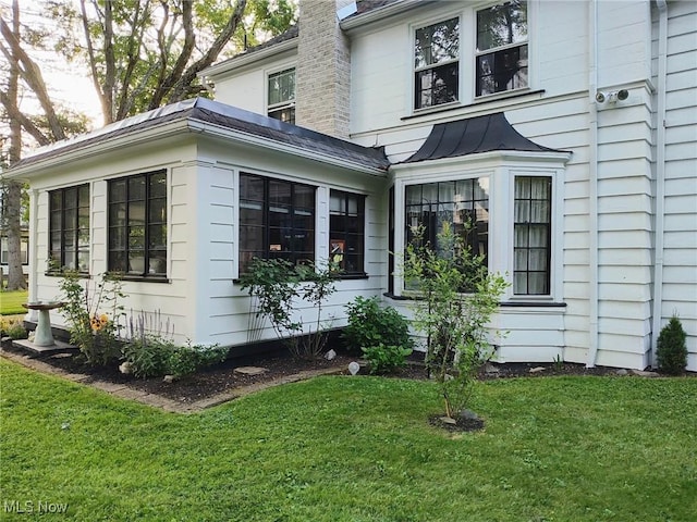 view of home's exterior featuring a lawn