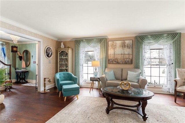 living area featuring wood-type flooring, an inviting chandelier, and ornamental molding