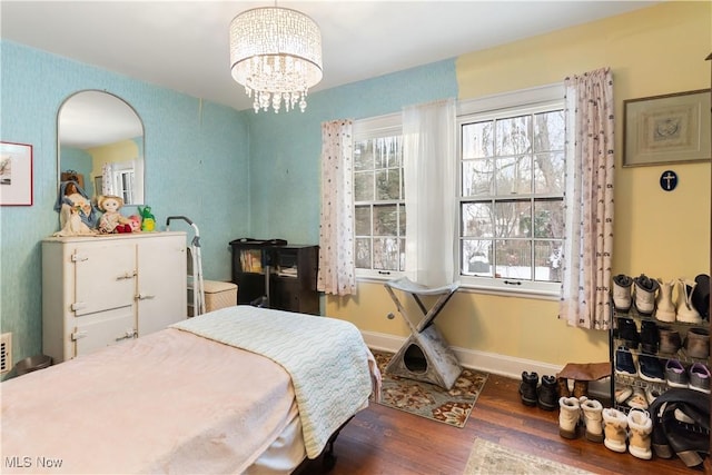 bedroom featuring dark hardwood / wood-style floors and a chandelier