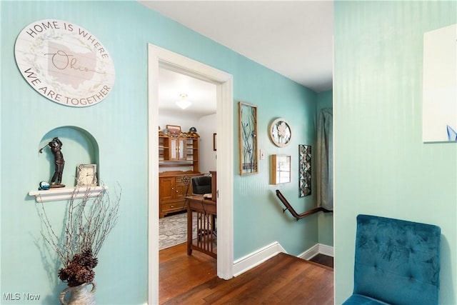 corridor with hardwood / wood-style floors