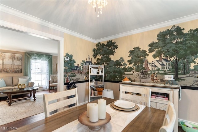 dining area with a chandelier, crown molding, and hardwood / wood-style flooring