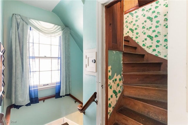 stairway with vaulted ceiling