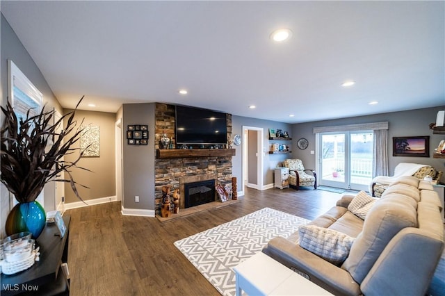 living room featuring dark wood-type flooring and a fireplace