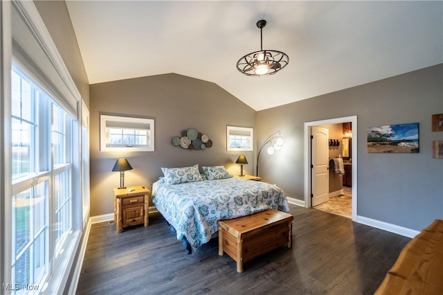 bedroom with ensuite bathroom, dark hardwood / wood-style flooring, and lofted ceiling