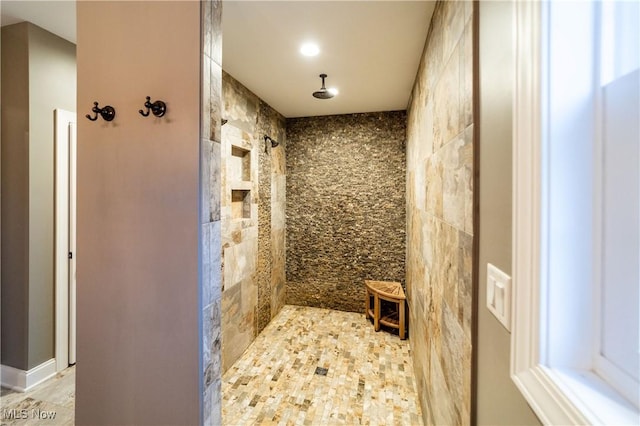 bathroom with tile walls and walk in shower