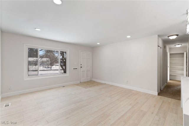 spare room with light wood-type flooring