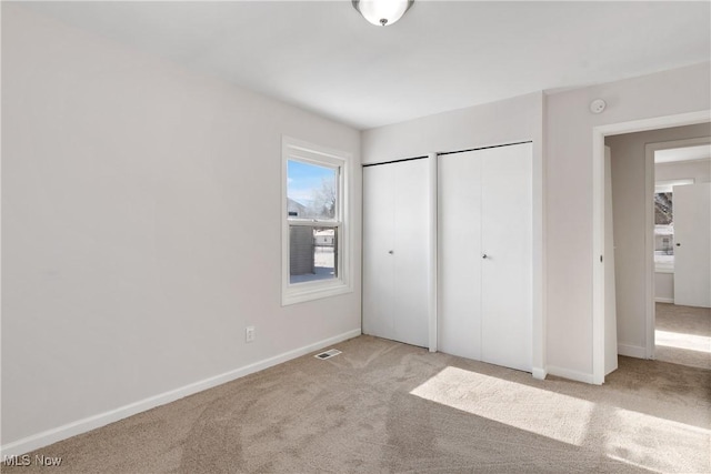 unfurnished bedroom with light carpet