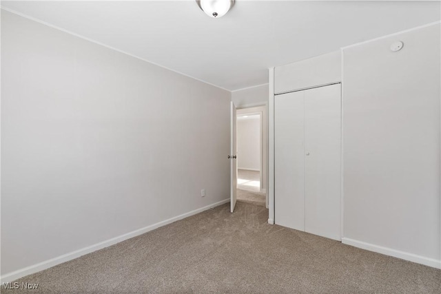 unfurnished bedroom with carpet and a closet