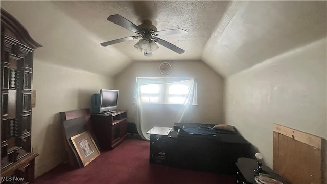 office space featuring a textured ceiling, ceiling fan, lofted ceiling, and dark carpet