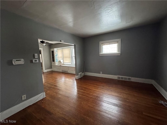 spare room with ceiling fan and dark hardwood / wood-style floors