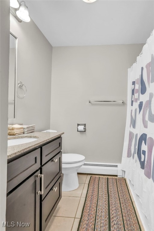 bathroom with baseboard heating, tile patterned floors, vanity, and toilet