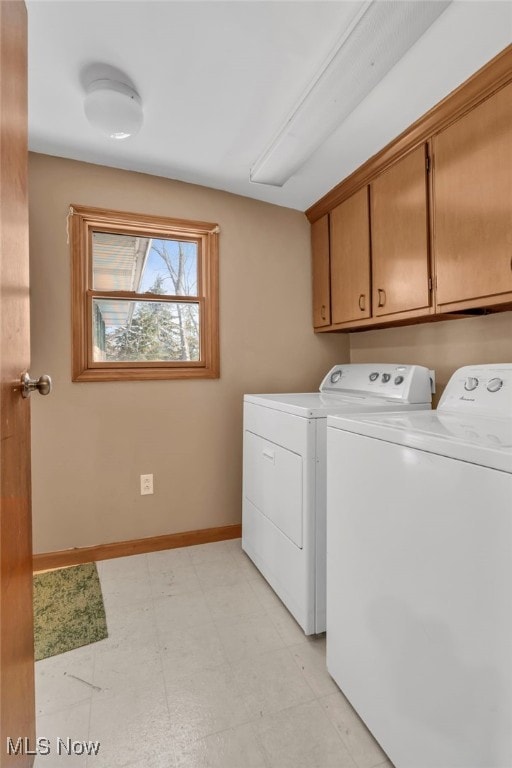 laundry room with cabinets and washer and clothes dryer