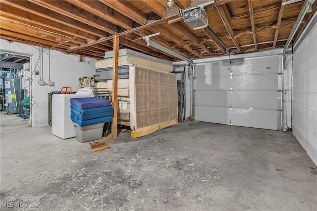 garage with washer / dryer, a garage door opener, and gas water heater