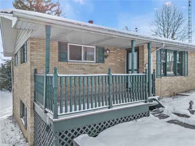 view of snow covered exterior featuring a porch