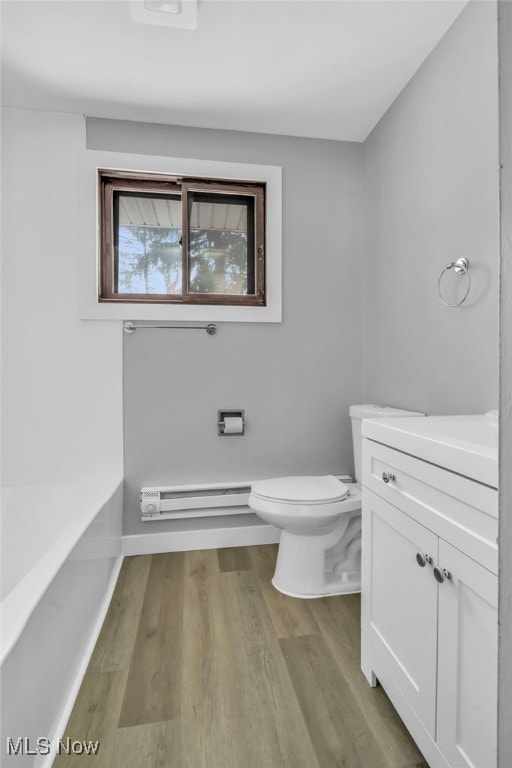 bathroom with a baseboard radiator, wood-type flooring, toilet, and vanity