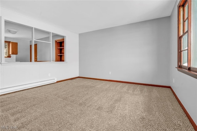 unfurnished room featuring carpet flooring and a baseboard radiator