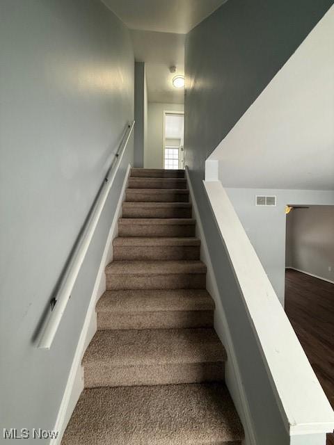 stairway featuring hardwood / wood-style floors