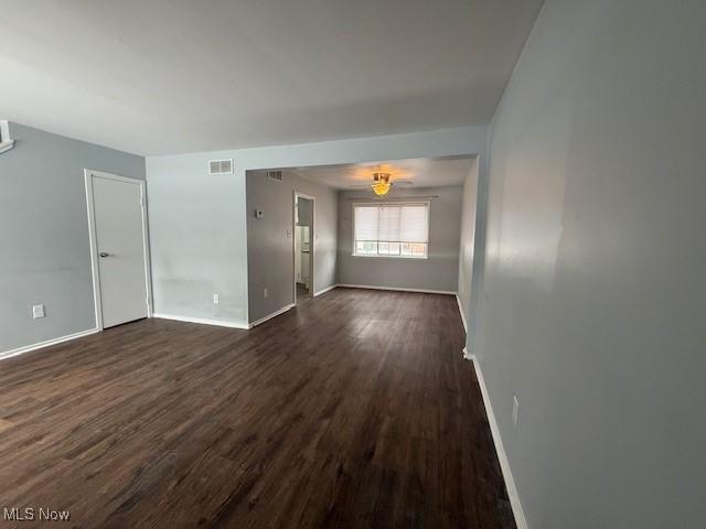 empty room with dark hardwood / wood-style floors