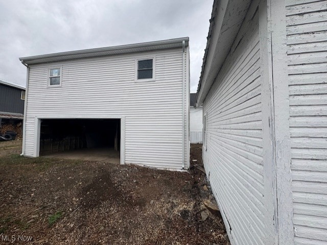 10630 Valley St, Trimble, OH 45782 - view of side of home with a garage