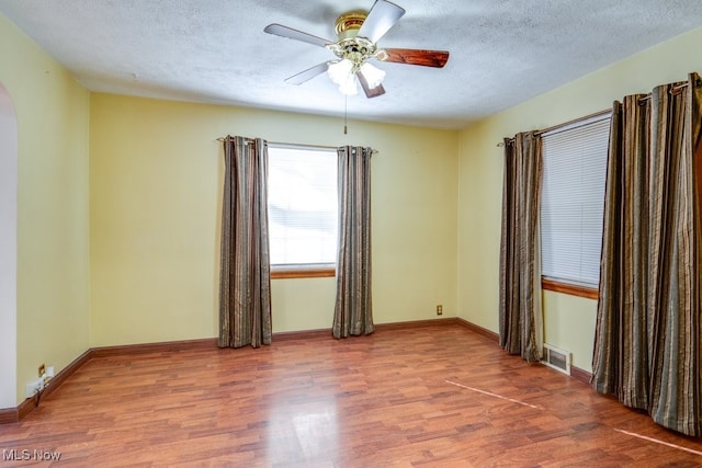 unfurnished room featuring ceiling fan, a textured ceiling, and hardwood / wood-style floors