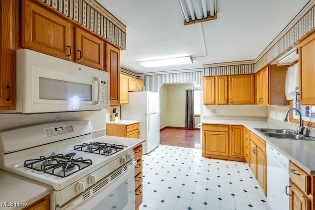 kitchen featuring sink and white appliances