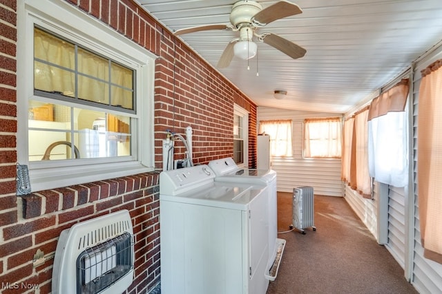 clothes washing area with washer and dryer, brick wall, carpet, ceiling fan, and heating unit