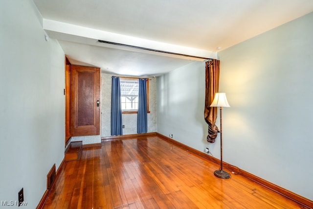 spare room featuring hardwood / wood-style flooring