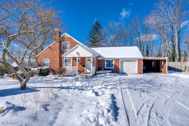 view of front of home with a garage and a carport