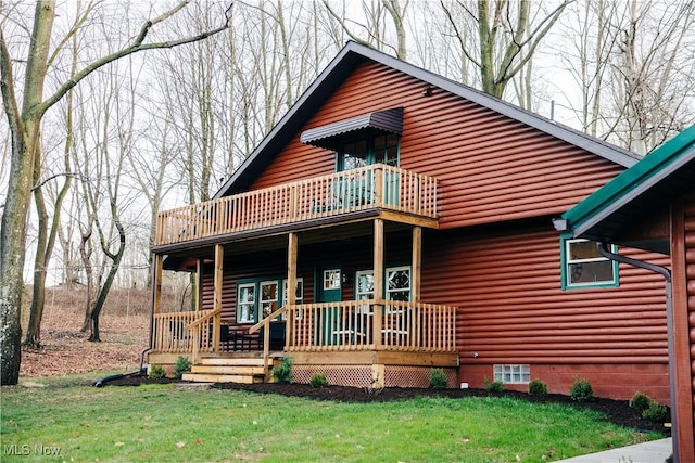 view of front of house with a front lawn, a balcony, and covered porch