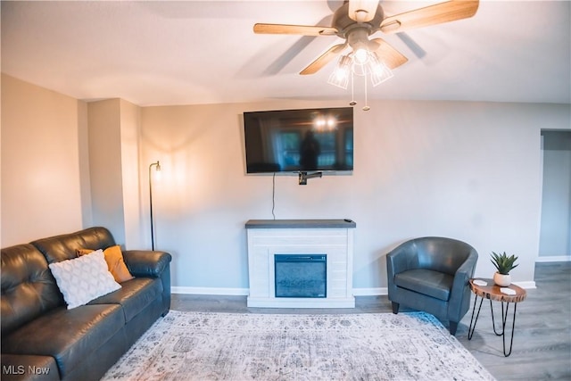 living room featuring ceiling fan and light hardwood / wood-style floors