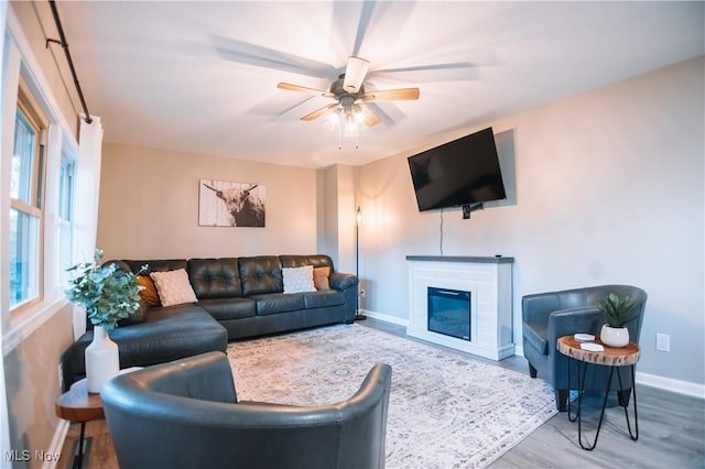 living room featuring hardwood / wood-style flooring and ceiling fan