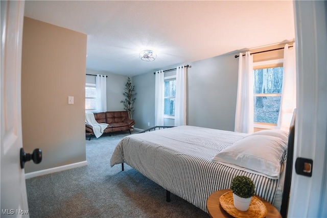 bedroom with dark colored carpet