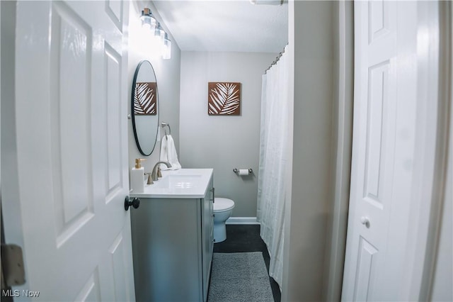 bathroom featuring toilet and vanity