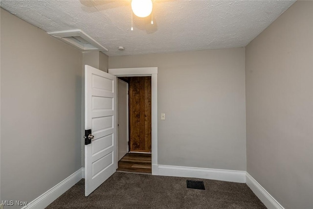 carpeted empty room with a textured ceiling