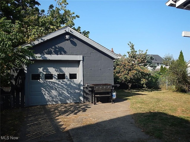 garage featuring a lawn