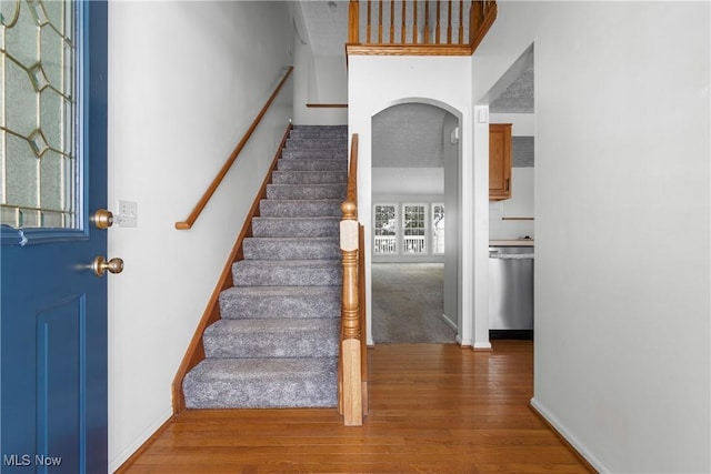 stairs with hardwood / wood-style floors