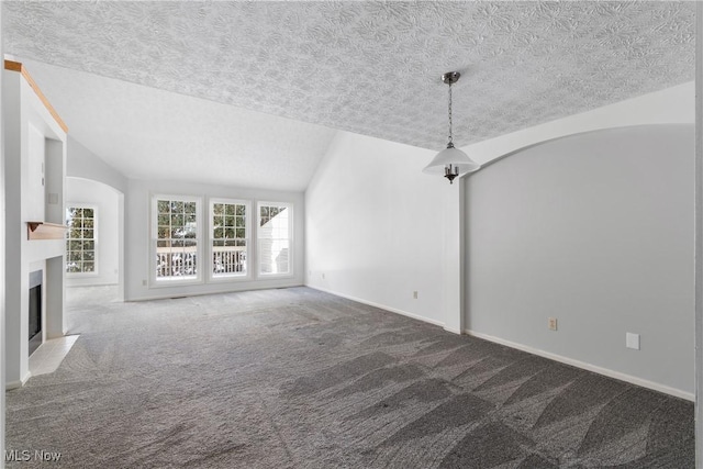 unfurnished living room with carpet flooring and lofted ceiling