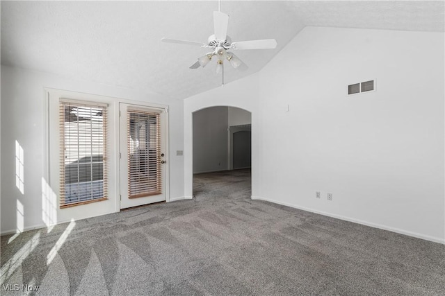 spare room with a textured ceiling, ceiling fan, carpet flooring, and lofted ceiling