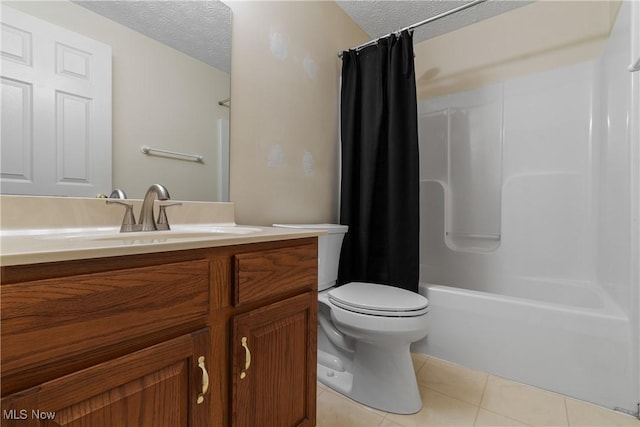 full bathroom featuring toilet, shower / bath combo, tile patterned flooring, a textured ceiling, and vanity