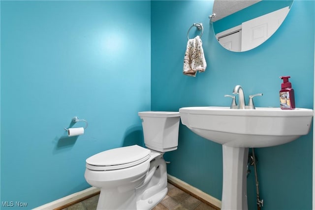 bathroom with toilet and tile patterned floors