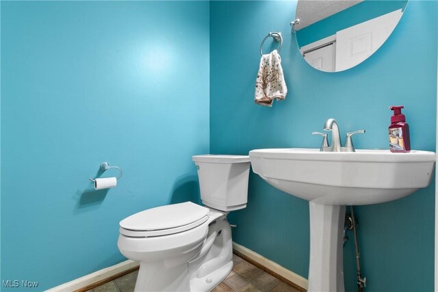 2834 Caxton Cir, Akron, OH 44312 - half bath featuring tile patterned floors, toilet, and baseboards