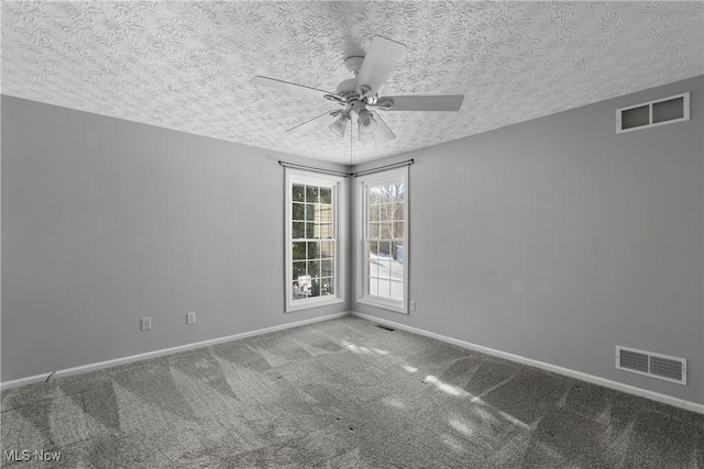 carpeted empty room featuring ceiling fan and a textured ceiling